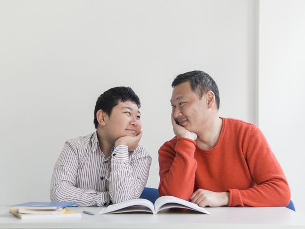 front-view-asian-father-son-looking-each-other_23-2148511492