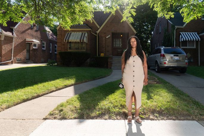 Alicia Lurry in front of her home on the west side of Detroit.