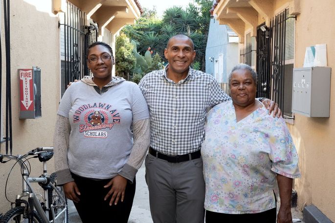 Martin Muoto, center, with tenants at a SoLa development in Los Angeles.