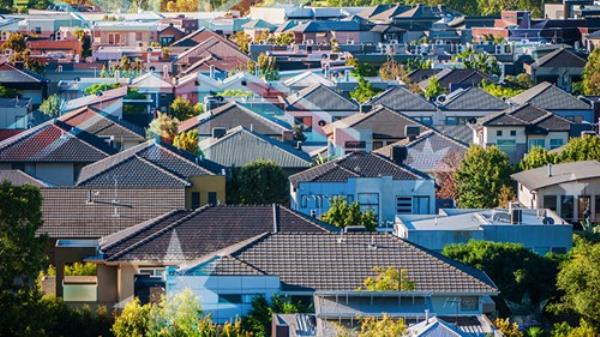 Rooftops in Melbourne suburb with Australian flag overlay
