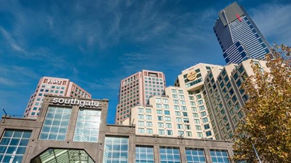 Street view of Southgate Shopping Mall along Southbank Promenade and modern high-rise buildings in diminishing perspective.