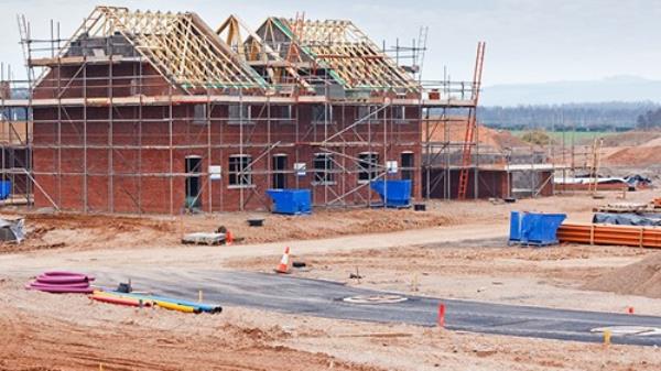 Partially built residential housing building site with estate homes in early stages of construction