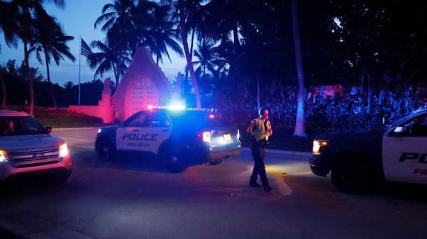 Police direct traffic outside an entrance to former President Donald Trump's Mar-a-Lago estate, Monday, Aug. 8, 2022, in Palm Beach, Fla. Trump said in a lengthy statement that the FBI was conducting a search of his Mar-a-Lago estate and asserted that agents had broken open a safe. (AP Photo/Terry Renna)