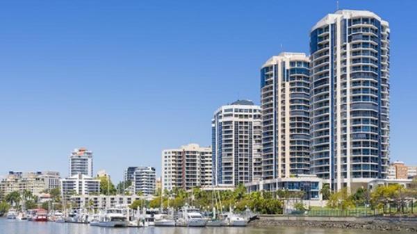 Modern waterfront apartments and yachts in marina in Brisbane during daytime