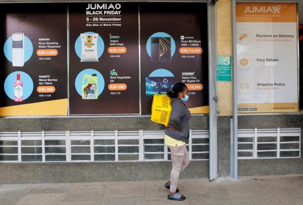 A woman walks outside a Jumia Technologies, pickup station in downtown Nairobi