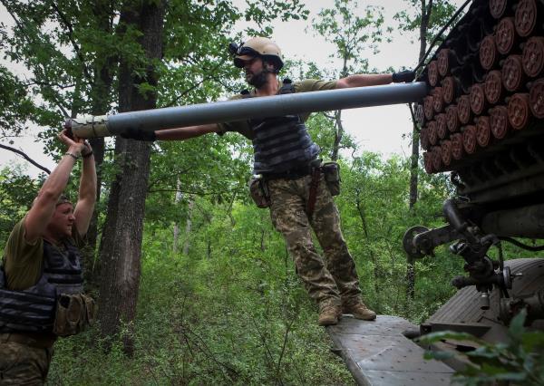 Ukrainian servicemen fire with a BM21 Grad multiple launch rocket system in a frontline in Kharkiv region