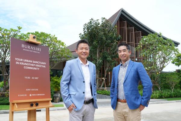 Arnut Kittikulmetee, executive vice-president, Project Development Department (Low Rise), Sansiri Plc, left, and, Takayuki Matsumoto, senior manager, Thailand Representative of Tokyu Corporation, stand in front of Burasiri Krungthep Kreetha, their joint venture project with 276 single detached houses priced between 14.99-40 million baht a unit.