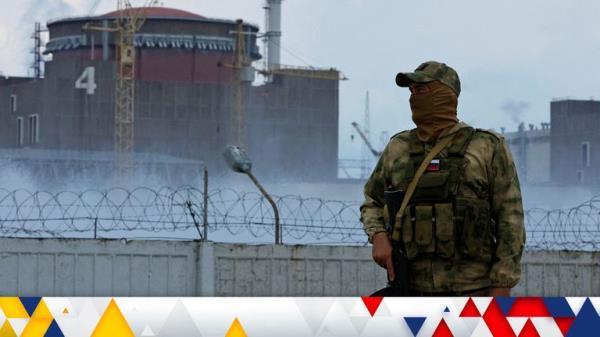 A serviceman with a Russian flag on his uniform stands guard near the Zaporizhzhia nuclear power plant on 4 August