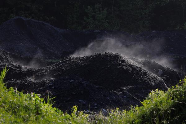 Steam rises from a pile of coal at a mine in Bishop