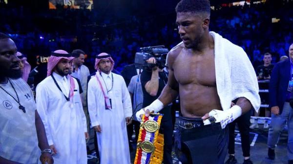 Anthony Joshua walks off with the belts after losing the World Heavyweight Championship WBA Super IBF, IBO and WBO fight against Oleksandr Usyk at the King Abdullah Sport City Stadium in Jeddah, Saudi Arabia. Picture date: Saturday August 20, 2022.