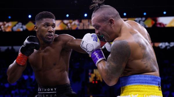 Anthony Joshua lands a punch on Oleksandr Usyk