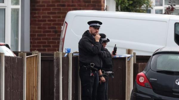 A police officer on duty at the scene in Kingsheath Avenue, Knotty Ash, Liverpool, where a nine-year-old girl has been fatally shot. Officers from Merseyside Police have started a murder investigation after attending a house at 10pm Monday following reports that an unknown male had fired a gun inside the property. Picture date: Tuesday August 23, 2022.

