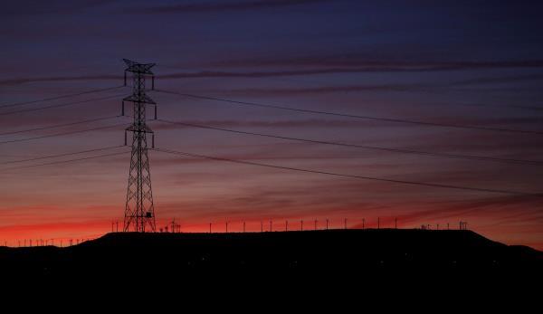 High-voltage power lines and an electricity pylon are seen near Pedrola