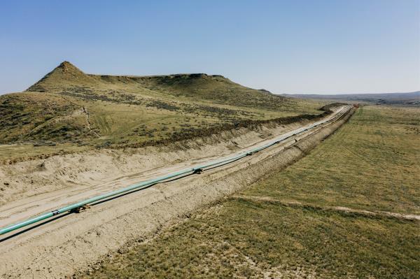 An extension of Denbury Inc's Greencore carbon pipeline is ready to be lowered into its trench, in Montana
