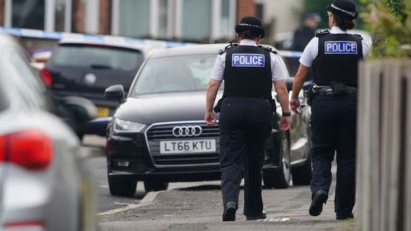 Police officers at the scene in Kingsheath Avenue, Knotty Ash, Liverpool, where a nine-year-old girl has been fatally shot. Officers from Merseyside Police have started a murder investigation after attending a house at 10pm Monday following reports that an unknown male had fired a gun inside the property. Picture date: Tuesday August 23, 2022.

