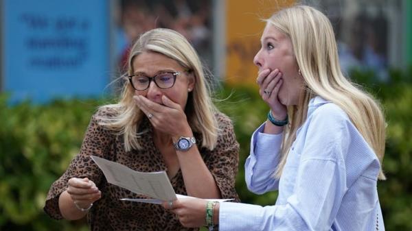 Maddie Hallam with her mother receiving her GCSE results at Norwich School, in Norwich, Norfolk. Picture date: Thursday August 25, 2022.

