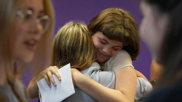 Students congratulate each other receiving their GCSE results at Roedean School, Roedean Way, Brighton in Brighton, Sussex. Picture date: Thursday August 25, 2022.


