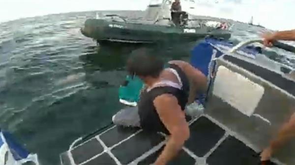 Men pulled to safety about boat started sinking off Boston coast. Pic: Boston Police