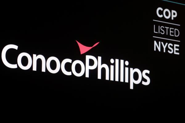A screen displays the logo for ConocoPhillips on the floor of the NYSE in New York
