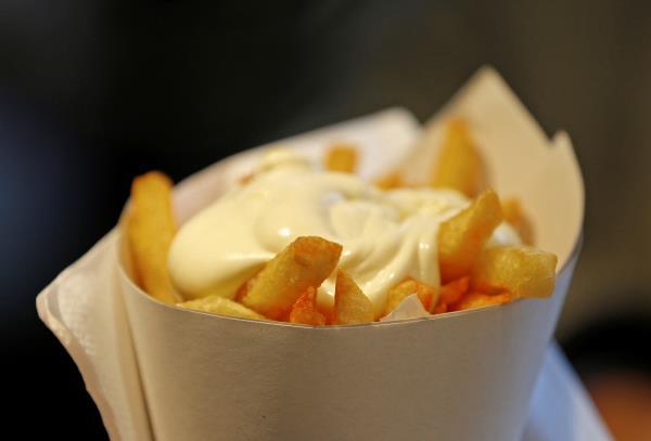 A large cone of fries with mayonnaise sauce is pictured at the Maison Antoine frites stand in Brussels