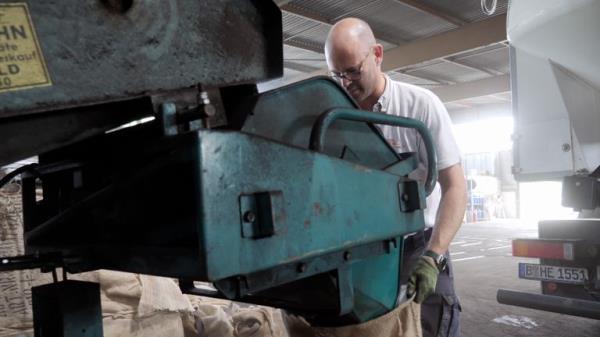 coal seller Frithjof Engelke, junior manager at ��Hans Engelke Energie�� in Berlin, bagging coal in his store