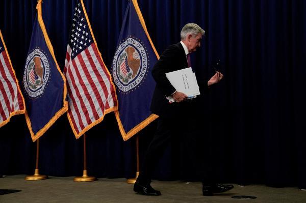 Federal Reserve Board Chair Jerome Powell leaves after a news conference, in Washington