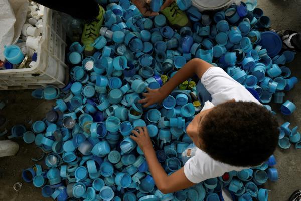 Venezuelan artist Oscar Olivares uses thousands of bottle caps to create colorful eco-mural, in Caracas