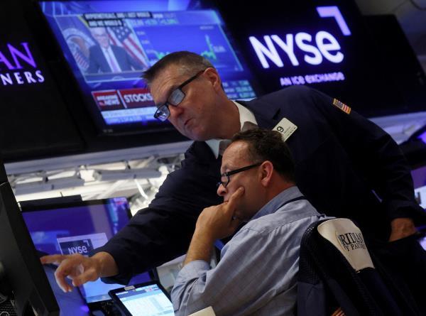 Traders work on the floor of the New York Stock Exchange (NYSE) in New York