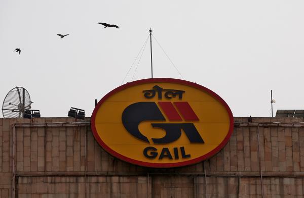 Birds fly past the logo of India's state-owned natural gas utility GAIL (India) Ltd in New Delhi