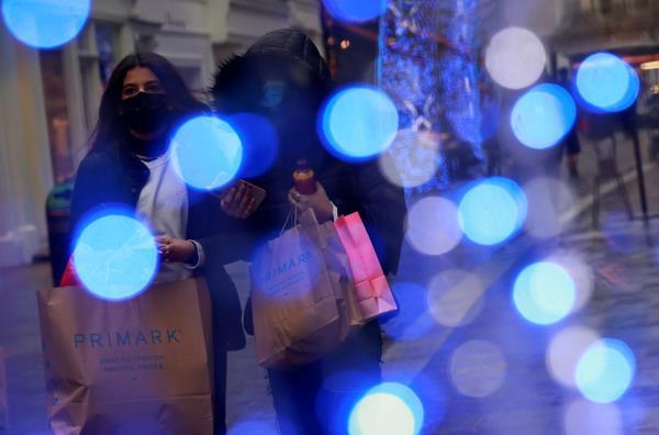 Shoppers walk down the street in London