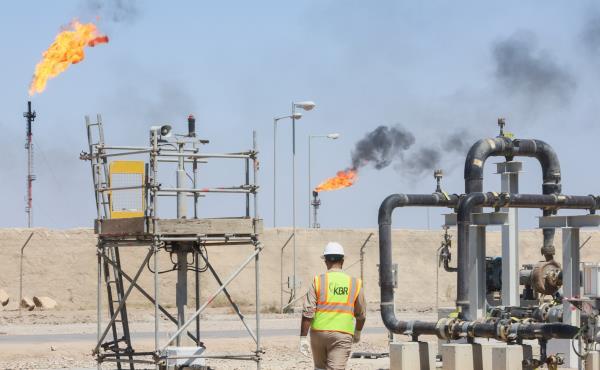 A worker walks at the Majnoon oil field, near Basra