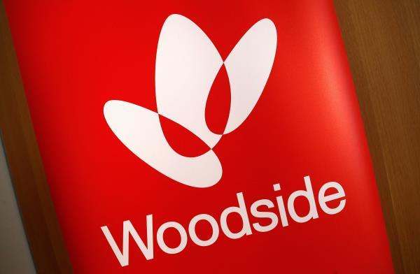 The logo for Woodside Petroleum, Australia's top independent oil and gas company, adorns a promotional poster on display at a briefing for investors in Sydney