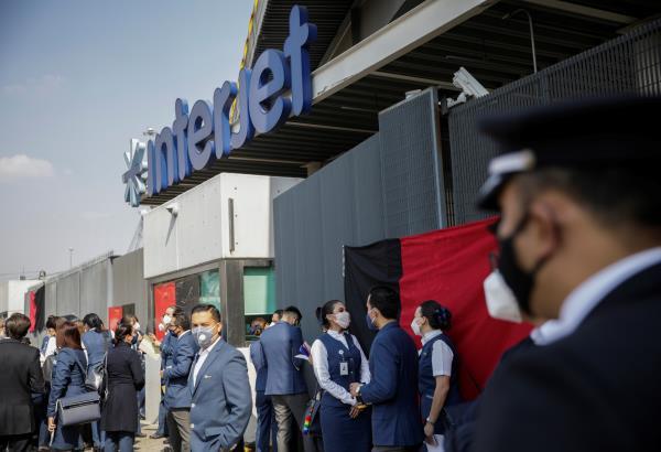 Unionized employees at Mexican airline Interjet stand outside the company's premises after going on strike, after weeks of flight cancellations as the company struggles to maintain operations during the COVID-19 pandemic, in Mexico City