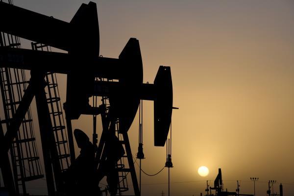 Pump jacks operate at sunset in Midland