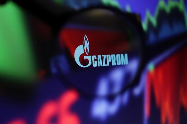 Illustration shows Gazprom logo and stock graph