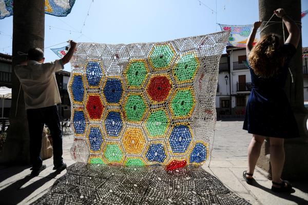 Weavers create parasols with recycled material to protect people from intense heat