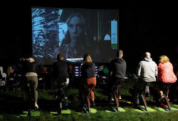 In Warsaw's main central park, a pop-up outdoor cinema invites viewers to pedal stationary bikes