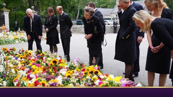 The Queen's children and grandchildren look at tributes outside Balmoral on Saturday