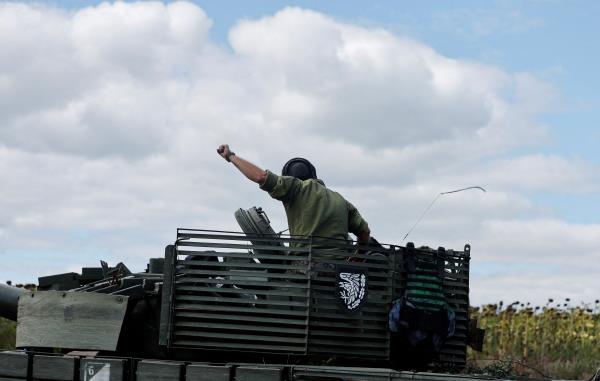Ukrainian servicemen drive near Bakhmut