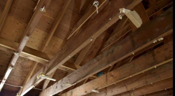 Removing a low, flat ceiling reveals a vaulted ceiling option