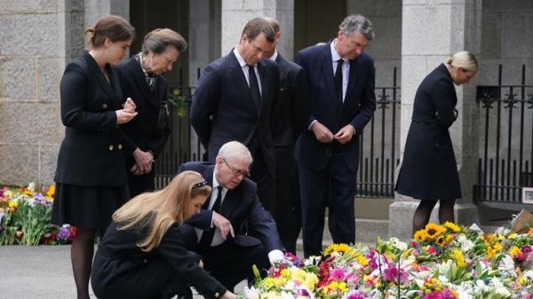 Britain's Princess Eugenie and Princess Beatrice are consoled by their father Prince Andrew as they look at the floral tributes for Queen Elizabeth II, outside the gates of Balmoral Castle in Aberdeenshire, Scotland Saturday, Sept. 10, 2022. (AP Photo/Scott Heppell)