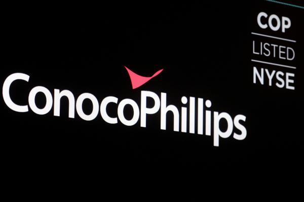 A screen displays the logo for ConocoPhillips on the floor of the NYSE in New York