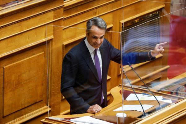 Greek PM Mitsotakis addresses lawmakers during a parliamentary on a wiretapping case in Athens