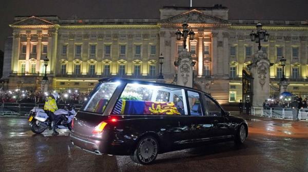 The hearse carrying the coffin of Queen Elizabeth II arrives at Buckingham Palace, London, where it will lie at rest overnight in the Bow Room. Picture date: Tuesday September 13, 2022.
