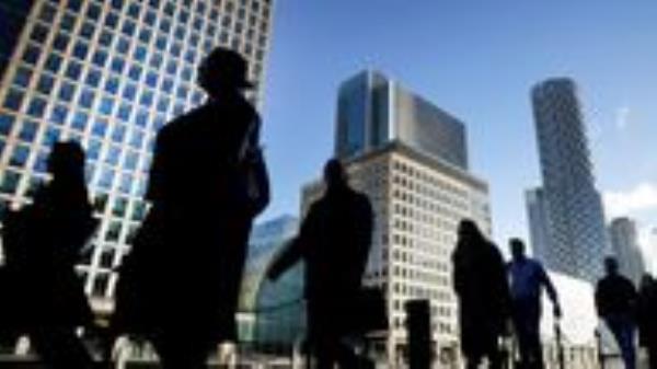 File photo dated 06/10/21 of office workers and commuters walking through Canary Wharf in London. The UK's biggest banks are no longer too big to fail and could continue to provide vital services even if they are going through a crisis, according to a report. Issue date: Friday June 10, 2022.
