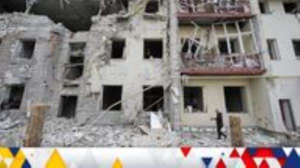 A man walks in a front of a residential building damaged by a Russian missile strike, amid Russia's attack on Ukraine, in Kharkiv, Ukraine September 12, 2022. REUTERS/Vyacheslav Madiyevskyy
