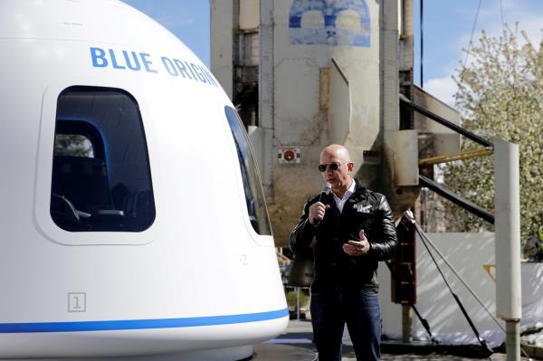 Amazon and Blue Origin founder Jeff Bezos addresses the media about the New Shepard rocket booster and Crew Capsule mockup at the 33rd Space Symposium in Colorado Springs