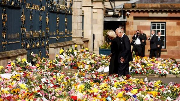 Britain's King Charles and Queen Camilla view the floral tributes at Hillsborough Castle, following the death of Queen Elizabeth, at Royal Hillsborough, Northern Ireland, September 13, 2022. REUTERS/Jason Cairnduff
