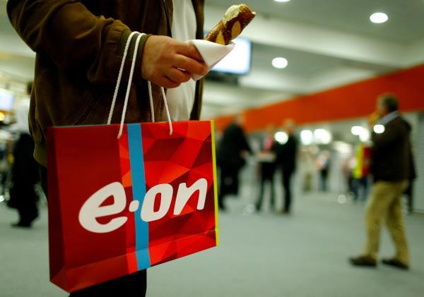 A shareholder carries a bag with the logo of E.ON during the company's annual shareholders meeting in Essen