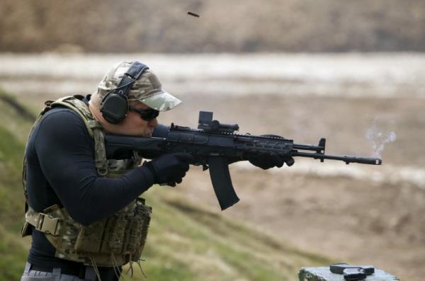 A participant fires a Kalashnikov AK-12 assault rifle at the Army-2015 international military-technical forum in Kubinka